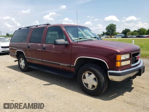 ✅ 1999 GMC Suburban • VIN: 1GKFK16R3XJ792220 • Lot: 66891295. Listed on Copart with 258,129 mi. Free auction sales archive from the USA and detailed vehicle history report at DreamBid. Image 4.