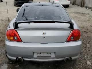 2003 Hyundai Tiburon GT z VIN KMHHN65F03U079618, wystawiony jako Copart lot #47642965 z przebiegiem 87 483 mil mil oraz Czysty tytuł • Clean title. Historia ofert i sprzedaży dostępna na DreamBid. Obrazek 6.