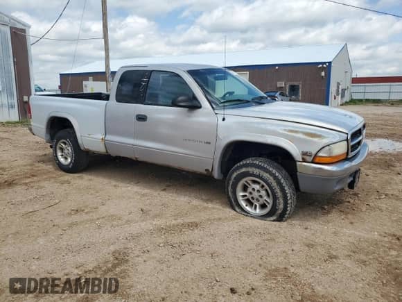 1999 Dodge Dakota SLT z VIN 1B7GG22X0XS268996, wystawiony jako Copart lot #58541515 z przebiegiem 189 899 mil mil oraz Czysty tytuł • Clean title. Historia ofert i sprzedaży dostępna na DreamBid. Obrazek 4.