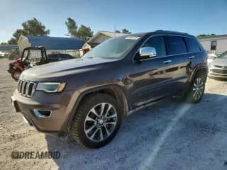 2018 Jeep Grand Cherokee Sterling z VIN 1C4RJFBG6JC259111, wystawiony jako Copart lot #61657125 z przebiegiem 134 642 mil mil oraz Czysty tytuł • Clean title. Historia ofert i sprzedaży dostępna na DreamBid. Obrazek 1.