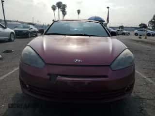 2007 Hyundai Tiburon GT z VIN KMHHN66F27U238272, wystawiony jako Copart lot #59218205 z przebiegiem 218 279 mil mil oraz Szkoda całkowita • Salvage title. Historia ofert i sprzedaży dostępna na DreamBid. Obrazek 5.