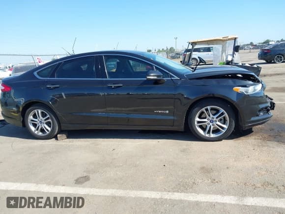 ✅ 2015 Ford Fusion Titanium Hybrid • VIN: 3FA6P0RU4FR214483 • Лот: 42327816. Опубликован ранее на IAAI с пробегом 149 007 миль. Бесплатный доступ к архиву аукционных продаж из США и подробный отчёт об истории автомобиля на DreamBid. Изображение 13.
