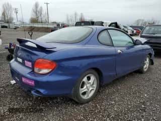 2001 Hyundai Tiburon z VIN KMHJG25F91U250108, wystawiony jako Copart lot #50905795 z przebiegiem 61 803 mil mil oraz Szkoda całkowita • Salvage title. Historia ofert i sprzedaży dostępna na DreamBid. Obrazek 3.