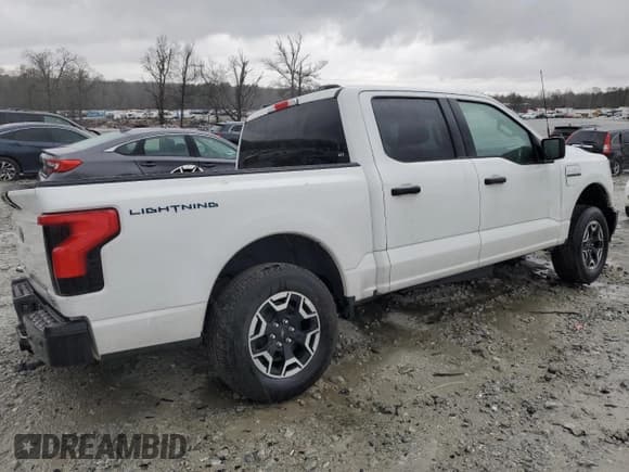 ✅ 2022 Ford F-150 Lightning Pro • VIN: 1FTVW1EL2NWG05249 • Лот: 44279714. Опубликован ранее на Copart с пробегом 28 990 миль. Бесплатный доступ к архиву аукционных продаж из США и подробный отчёт об истории автомобиля на DreamBid. Изображение 3.