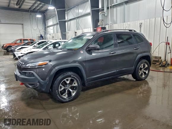 ✅ 2015 Jeep Cherokee Trailhawk • VIN: 1C4PJMBSXFW570174 • Lot: 94323375. Listed on Copart with 138,885 mi. Free auction sales archive from the USA and detailed vehicle history report at DreamBid. Image 1.
