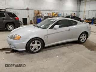2004 Hyundai Tiburon с VIN KMHHM65D04U131767, выставлен на аукционе Copart как лот 81593054 с пробегом 67 235 миль миль и Чистый • Clean title. История ставок и продаж доступна на DreamBid. Изображение 1.