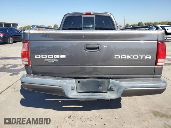 2003 Dodge Dakota Sport z VIN 1D7HL32X63S218920, wystawiony jako Copart lot #76013444 z przebiegiem 142 224 mil mil oraz Czysty tytuł • Clean title. Historia ofert i sprzedaży dostępna na DreamBid. Obrazek 6.