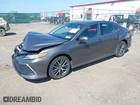 2022 Toyota Camry Hybrid XLE with VIN 4T1F31AK2NU597994, listed as a IAAI auction lot 42550485 with 71,900 mi miles and . Bid and sale history available at DreamBid. Image 2.