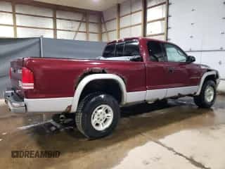 2000 Dodge Dakota Sport z VIN 1B7GG22NXYS573079, wystawiony jako Copart lot #66582204 z przebiegiem 128 435 mil mil oraz Czysty tytuł • Clean title. Historia ofert i sprzedaży dostępna na DreamBid. Obrazek 3.