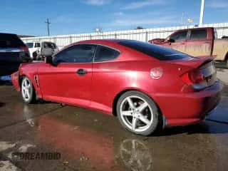 2006 Hyundai Tiburon GT z VIN KMHHN65F16U207031, wystawiony jako Copart lot #83851394 z przebiegiem 119 625 mil mil oraz Szkoda całkowita • Salvage title. Historia ofert i sprzedaży dostępna na DreamBid. Obrazek 2.