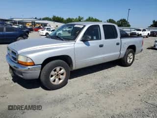 2004 Dodge Dakota SLT with VIN 1D7HL48K44S780575, listed as a Copart auction lot 57872335 with 148,785 mi miles and Salvage title. Bid and sale history available at DreamBid. Image 1.