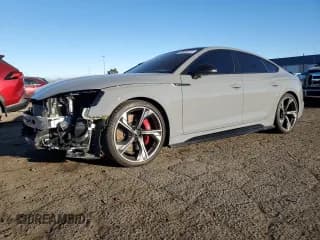 ✅ 2023 Audi RS 5 Sportback • VIN: WUAAWCF56PA900738 • Lot: 92566815. Listed on Copart with 26,456 mi. Free auction sales archive from the USA and detailed vehicle history report at DreamBid. Image 1.