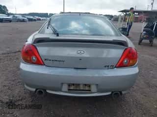 2003 Hyundai Tiburon GT z VIN KMHHN65F63U036899, wystawiony jako IAAI lot #42148935 z przebiegiem 203 485 mil mil oraz . Historia ofert i sprzedaży dostępna na DreamBid. Obrazek 6.