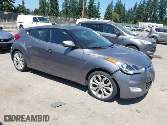 2012 Hyundai Veloster w/Black Int with VIN KMHTC6AD5CU030788, listed as a IAAI auction lot 42774337 with 104,297 mi miles and . Bid and sale history available at DreamBid. Image 1.