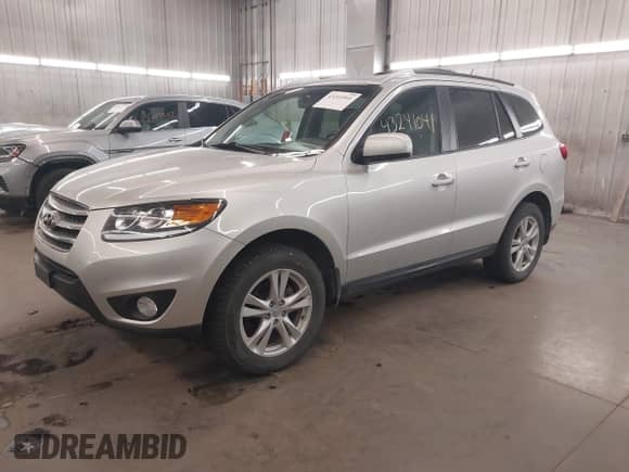 2012 Hyundai Santa Fe SE with VIN 5XYZHDAG5CG129742, listed as a IAAI auction lot 43241041 with 95,818 mi miles and . Bid and sale history available at DreamBid. Image 2.