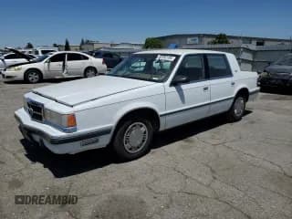 ✅ 1989 Dodge Dynasty • VIN: 1B3BC463XKD594439 • Lot: 65792195. Listed on Copart with 61,970 mi. Free auction sales archive from the USA and detailed vehicle history report at DreamBid. Image 1.