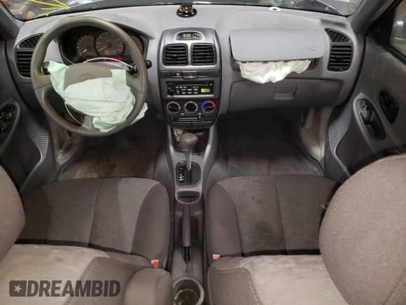 2004 Hyundai Accent GL with VIN KMHCG45C24U564570, listed as a Copart auction lot 82090484 with 69,000 mi miles and Salvage title. Bid and sale history available at DreamBid. Image 8.