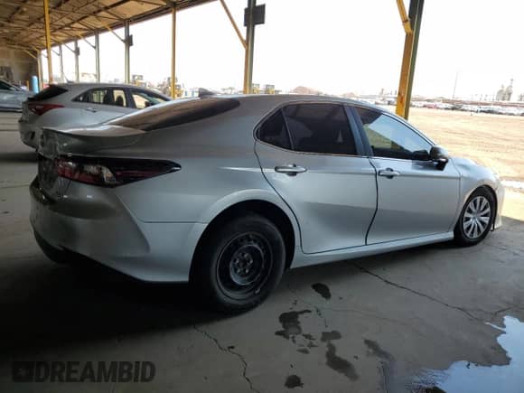 2021 Toyota Camry Hybrid LE with VIN 4T1C31AK5MU554381, listed as a Copart auction lot 69998775 with 104,313 mi miles and Salvage title. Bid and sale history available at DreamBid. Image 3.