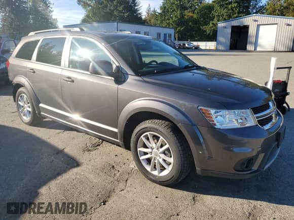 2015 Dodge Journey SXT with VIN 3C4PDCBB1FT698097, listed as a Copart auction lot 85335395 with 103,167 mi miles and Salvage title. Bid and sale history available at DreamBid. Image 4.